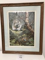 Framed wildlife print featuring a raccoon near a birch tree in a forest habitat with blue eggs visible. Signed and numbered artist proof.