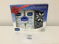 Front view of gift pack containing Vaseline lotion tubes, lip therapy jar and knit glove.