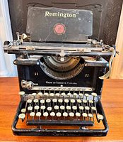 Front view of the Remington typewriter with visible keys, carriage and top panel showing brand and model markings.