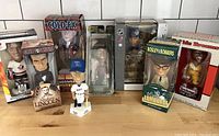 Full view of the mixed lot of 8 bobbleheads showing a variety of characters including sports figures and historical person Abraham Lincoln.