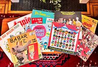 Photo showing the full assortment of vintage kids vinyl records spread out displaying colorful illustrated covers including Babar, The Ugly Duckling, Sesame Street, Dr. Seuss, and others.