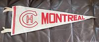 Full view of the grey felt pennant with red Montreal Canadiens logo and 'MONTREAL' text.