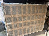 Photo of old box spring showing fabric cover from the underside