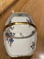 Top view showing floral design and gold handle