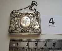 Front view showing embossed floral and ribbon design with monogram