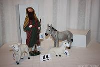 Group shot showing shepherd, two sheep and donkey with lot number marker