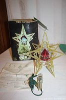 Star topper assembled with cord, instructions and box visible