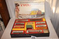Photo showing original large box with colorful train artwork and layout including all contained boxed freight train cars and engine.