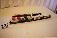 Full view of diesel engine and attached three cabooses showing 'Spirit of 76' paint scheme