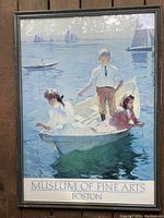 Framed vintage art poster showing three children in a boat on calm water, sailboats in background, captioned "Museum of Fine Arts Boston."