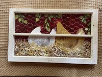 Full view of the painted window sash showing two chickens eating peas with straw bedding and pea pods on a dark red background