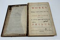 Open book showing title page 'The Works of King Charles I Both Civil and Sacred With the Life and Reign of That Prince' printed in London by T. Read in 1735. Visible loose pages and signs of age.