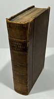 Spine and side view of 1866 Godey's Lady's Book and Magazine showing brown leather cover and gilt title on spine.