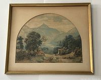 Full view of framed watercolor painting depicting mountain landscape with trees, river, and two figures near stone monument.