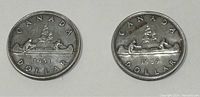 Photo showing the obverse sides of both 1951 and 1959 Canadian silver dollar coins with the canoe design.