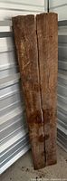 Two rustic barn wood planks standing vertically, showing natural wood grain and some wear.