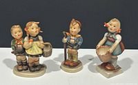 Photo showing three Goebel Hummel figurines from front angle