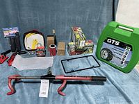 Full view of various auto and motorcycle accessories including tow rope, battery cables, filters, wheel lock, tire chains, and tools.