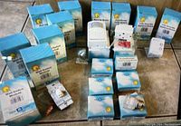 Photo showing original boxed electrical modules including wall switches, super sockets, and appliance modules arranged on a floor.