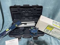 Mastercraft laser level with adjustable tripod, blue laser level and silver tripod in black plastic carrying case with manual.