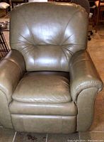 Front view of a grey leather La-Z-Boy recliner chair showing padded armrests, cushioned back and seat.