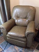 Front view of khaki leather recliner chair showcasing padded backrest, armrests and cushioned seat.