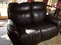 Front angle view showing entire loveseat and leather upholstery