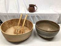 Photo showing the maple salad bowl with wooden serving utensils beside a large ceramic bowl.