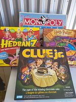 Box set showing front of Monopoly Junior, Hedbanz, Harry Potter Trivia, Clue Jr. games.