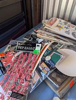 Photo of assorted scrapbook embellishments and alphabet sticker sheets in pink and red shades.