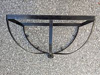 Top view of metal pot hanger showing two parallel rectangular base bars and curved metal side supports