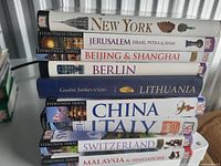 Stack of nine Eyewitness Travel guidebooks including New York, Jerusalem, Beijing & Shanghai, Berlin, Lithuania, China, Italy, Switzerland, Malaysia & Singapore