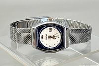 Front angle showing entire watch with mesh band and case details.