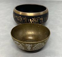 View showing the two singing bowls side by side, highlighting the exterior designs and sizes.