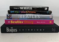 Front view of five Beatles-related books stacked with titles visible.
