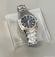 Front three-quarter view of watch on clear stand