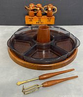 Image of the Three Wise Monkeys bar set on a wooden base with Speak No Evil, See No Evil, Hear No Evil carved monkeys, alongside the lazy Susan and bar utensils visible.