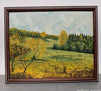 Full view of vintage framed landscape painting showing autumn trees and hills.
