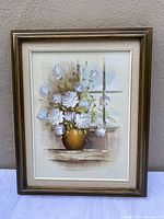 Full view of the framed floral painting on canvas showing bouquet of white and lavender flowers in gold vase by a window.