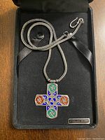 Sterling silver cross pendant necklace in a black presentation box with a 'STERLING SILVER' label.