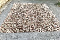 Full top-down view of entire rug laid on pavement showing overall design and dimensions