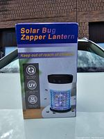 Photo of the retail box showing product name Solar Bug Zapper Lantern with features like 360° mosquito trapping, UV light attraction, and chemical-free operation.