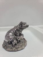 View of the sterling silver pig family sculpture, highlighting the sow and three piglets on a textured base.