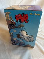 Display of the Bone graphic novel series slipcase with colorful artwork by Jeff Smith.