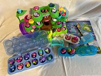 Photo showing the Hatchimals nest play structure, numerous individual Hatchimals toys, and plastic egg carrying cases.