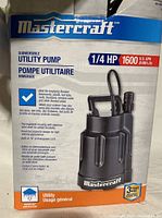 Box showing Mastercraft branding and product specifications: 1/4 HP, 1600 US GPH (6000 L/hr) utility pump. Describes thermoplastic housing and suitability for pumping water from flooded basements and other wet areas.