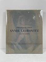 Front cover of the book "Photographs Annie Leibovitz 1970-1990" with original acetate dust jacket visible.