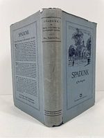 Front and spine view of the hardcover book with dust jacket, blue cover with black and white illustration and text including author's name and title.
