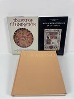 Three hardcover books standing upright: The Art of Illumination with a white cover and circular manuscript art image, Manuscrits Médiévaux de Chambéry with a black cover and manuscript image, Paradiso with a plain tan hardcover.