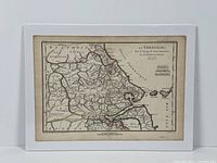 Photo of the antique engraved map titled La Thessalie, showing the full map with colored borders and Greek region details.